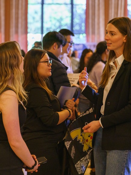 Employer talking to 2 students at a career fair