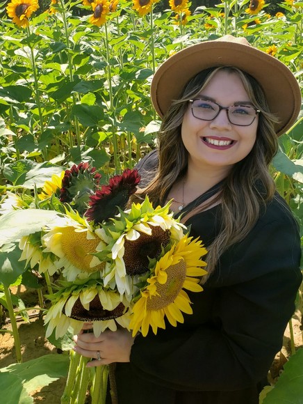 Kabrianna Tamura holding sunflowers