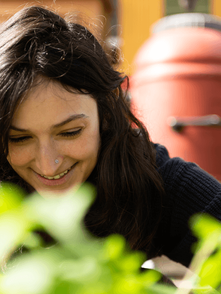 Emerald Niakan smelling flowers