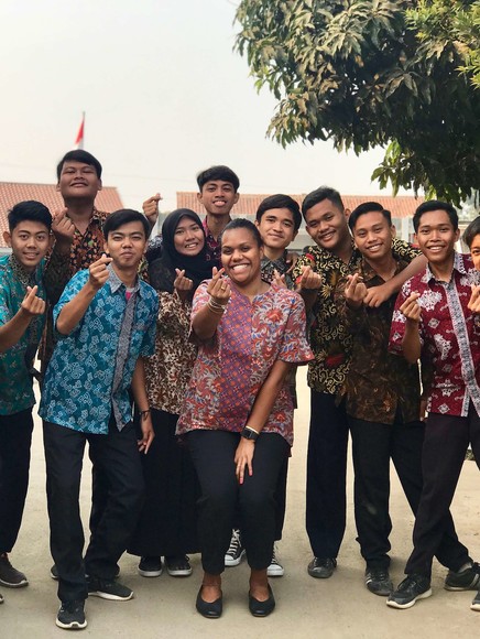 A group of young people posing for a picture.