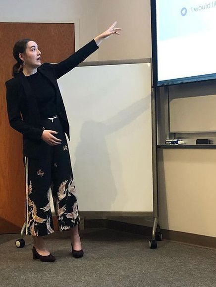 A student pointing at a Powerpoint slide