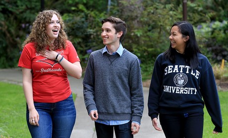 Three students walking and laughing