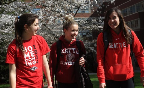 Three students walking and laughing