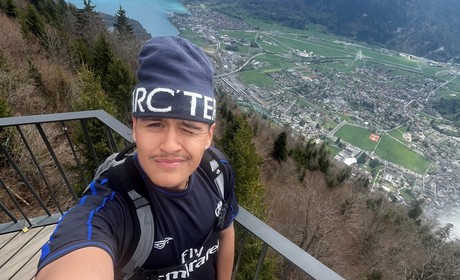 Student on a hike in front of mountain view