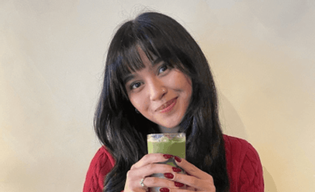 A student with an iced strawberry matcha latte