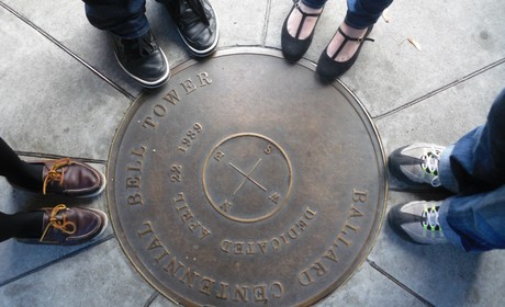 Photo of people's feet standing around a plaque