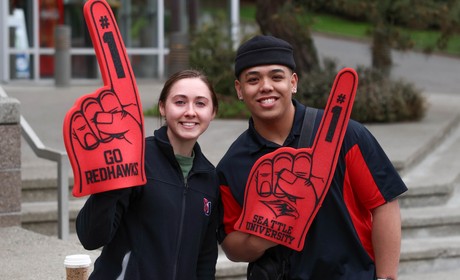 Students holding large foam #1 hands