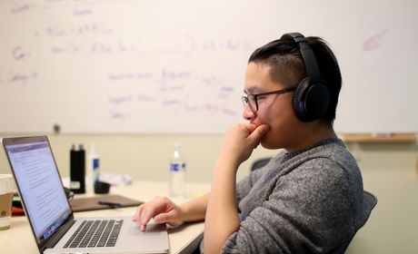 Student looks at laptop during finals week