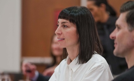 A woman sitting by a table