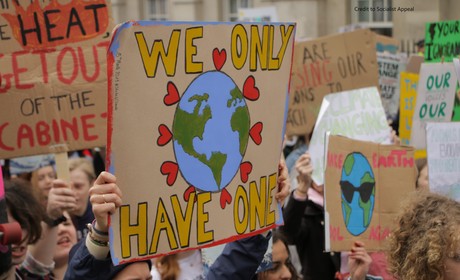 Photo of poster at climate march with drawing of Earth text we only have one