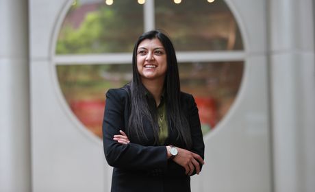 Student in front of a building on campus