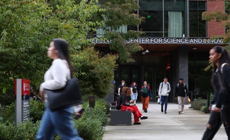 Image of students walking across campus during the Fall.