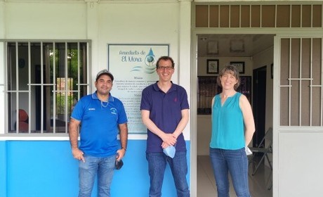 three people outside a shop