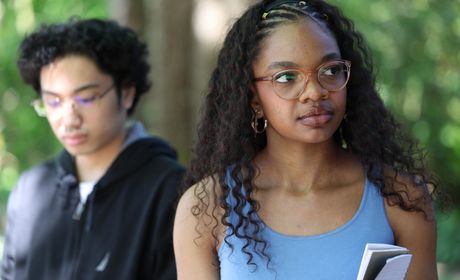 Medium close-up shot of Seattle University students outside with trees in the background.