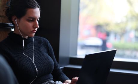 Seattle University student working on a laptop.