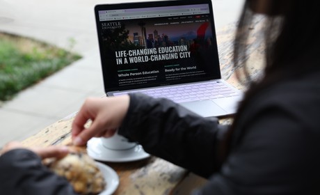 Student on laptop browsing Seattle U website