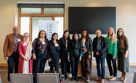 Speakers posing for candid photo
