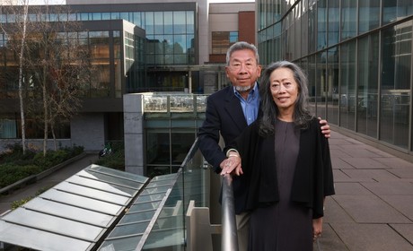 Evelyn and Gary Eng stand on balcony on SU campus