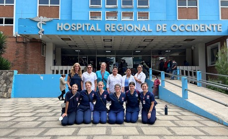 Students and faculty standing in front of Hospital Regional de Occidente during a study abroad course