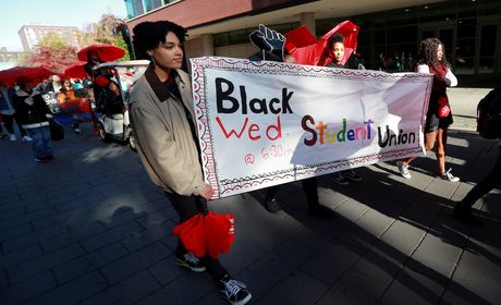Members of the Black Student Union holding up a sign