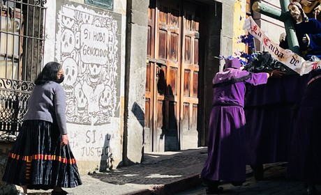A person pushing a cart up an alley