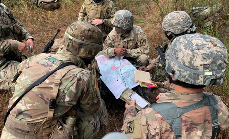 Cadets plan around a map in training