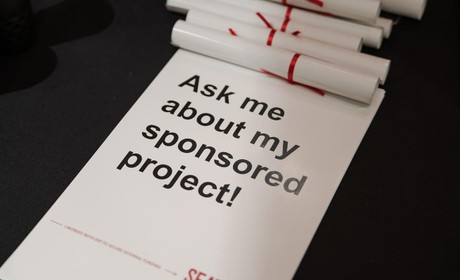 Poster stating “ask me about my sponsored project!”