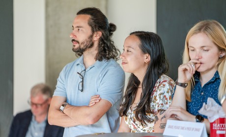 Three students listening to a presentation at the MIT Equity Showcase