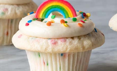 A cupcake with a rainbow topper