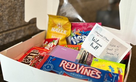 white cardboard box filled with various candy bars