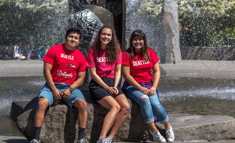 Students sitting in front of fountain