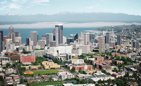 Aerial view includes water and mountains, Seattle University's campus and the city.