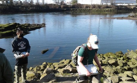 Students collect information near a body of water