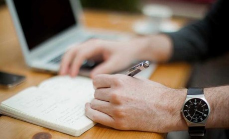Hand holding a pen writing