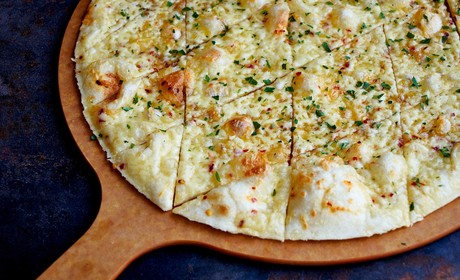 A pizza peel with a pizza on top