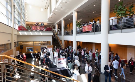 A group of people standing in a lobby.