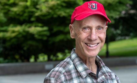 Professor Bill Weis in a red Seattle University baseball cap