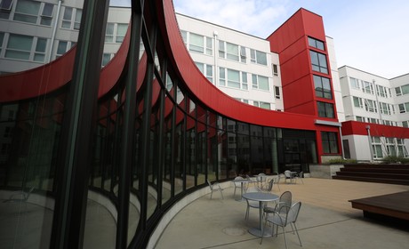 A red and white building with a courtyard.