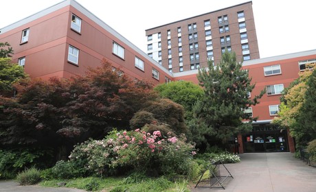 A building with trees and bushes.