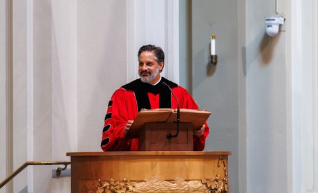 President Peñalver in regalia standing at a podium
