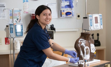 A nurse working on a mannequin.