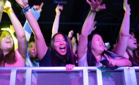 A group of people with their arms raised.