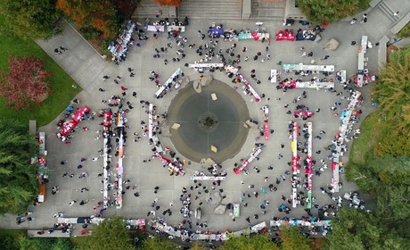 An aerial photo of students at the SU fountain