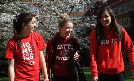 Three students walking and laughing