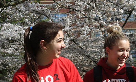 Three students walking and laughing