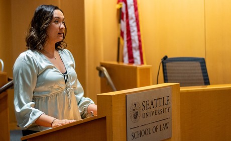 a person standing at a podium in the School of Law