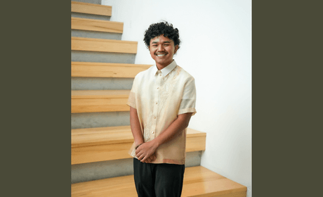 Jacob Caddali standing in front of stairs