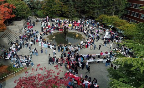 A large group of people gathered around a fountain.