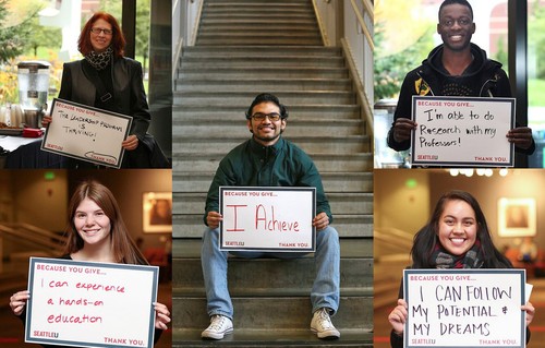 male student sitting on a staircase holding a sign of gratitude