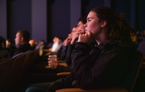 student listening to an Albers executive speaker